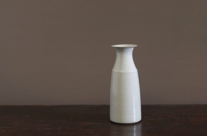 wheel thrown dark stoneware vase with off-white glaze reduction fired by award winning potters James and Tilla Waters in Carmarthenshire, Wales, UK
