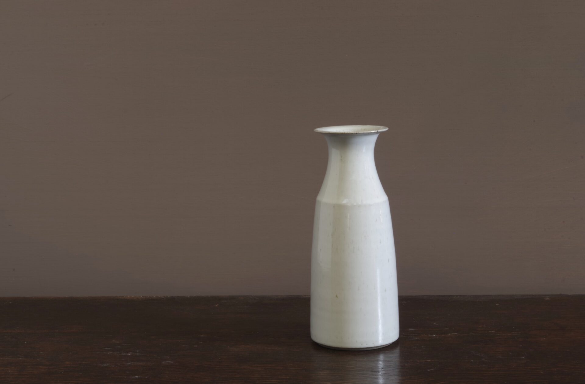 wheel thrown dark stoneware vase with off-white glaze reduction fired by award winning potters James and Tilla Waters in Carmarthenshire, Wales, UK