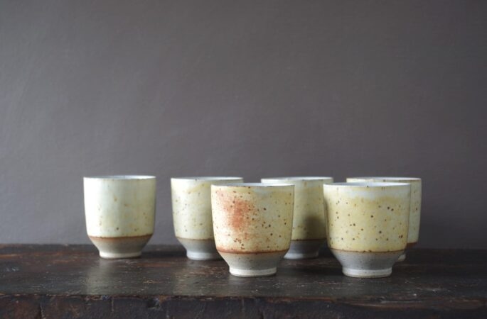reduction fired thrown stoneware beaker with soft yellow glaze by award winning studio potters James and Tilla Waters in Carmarthenshire, Wales