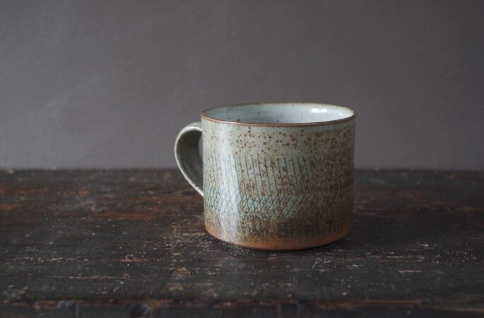 reduction fired thrown stoneware breakfast mug with pulled handle and inlaid decoration by award winning studio potters James and Tilla Waters in Carmarthenshire, Wales