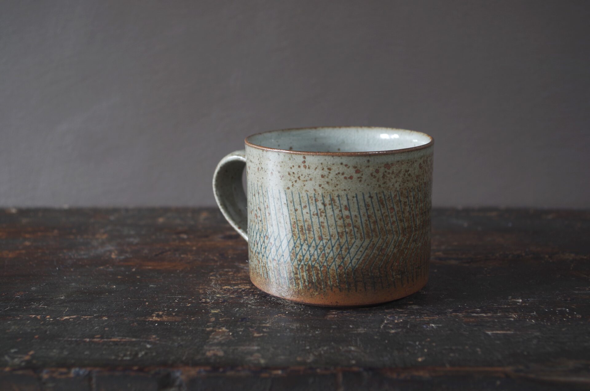 reduction fired thrown stoneware breakfast mug with pulled handle and inlaid decoration by award winning studio potters James and Tilla Waters in Carmarthenshire, Wales