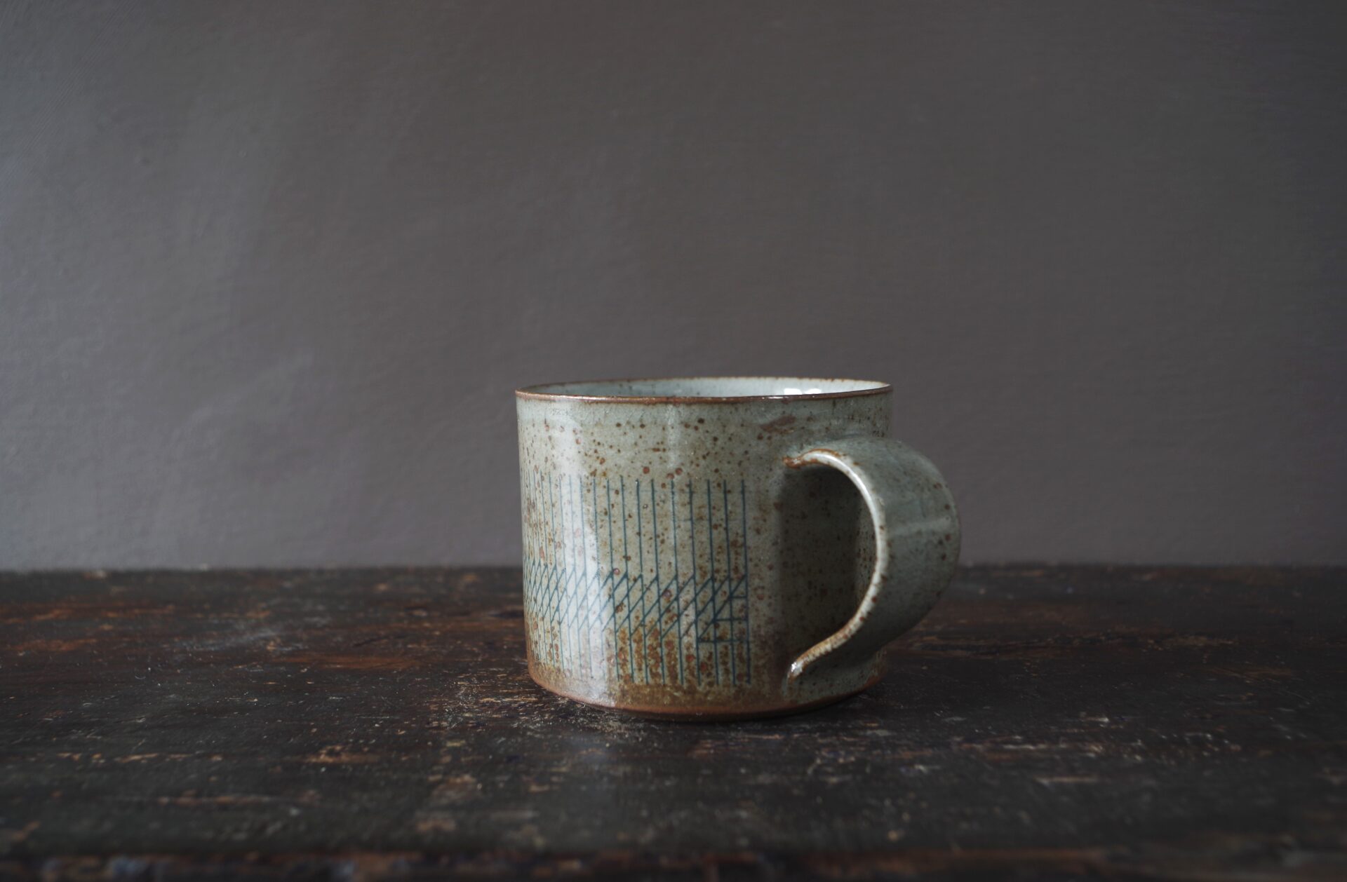 reduction fired thrown stoneware breakfast mug with pulled handle and inlaid decoration by award winning studio potters James and Tilla Waters in Carmarthenshire, Wales