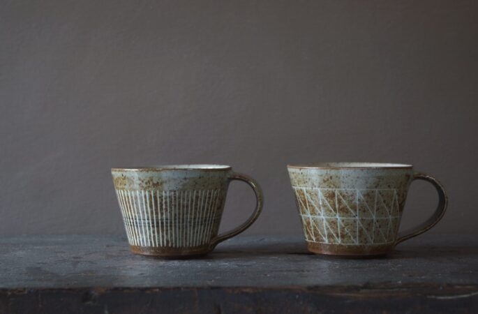 Reduction fired, wheel thrown, stoneware coffee cup with pulled handle and hand decorated with inlay by award winning studio potters James and Tilla Waters in Carmarthenshire, Wales, UK