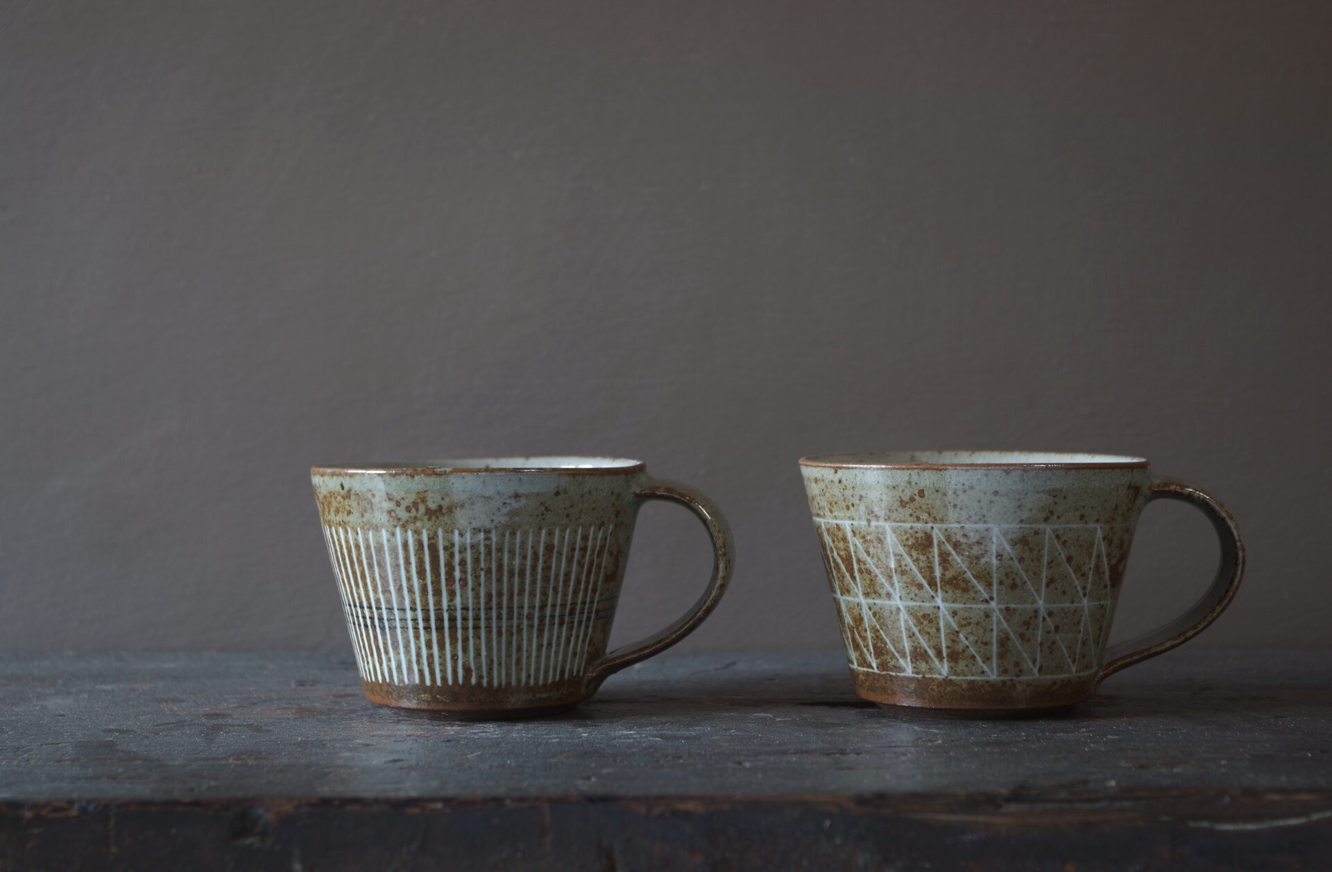 Reduction fired, wheel thrown, stoneware coffee cup with pulled handle and hand decorated with inlay by award winning studio potters James and Tilla Waters in Carmarthenshire, Wales, UK