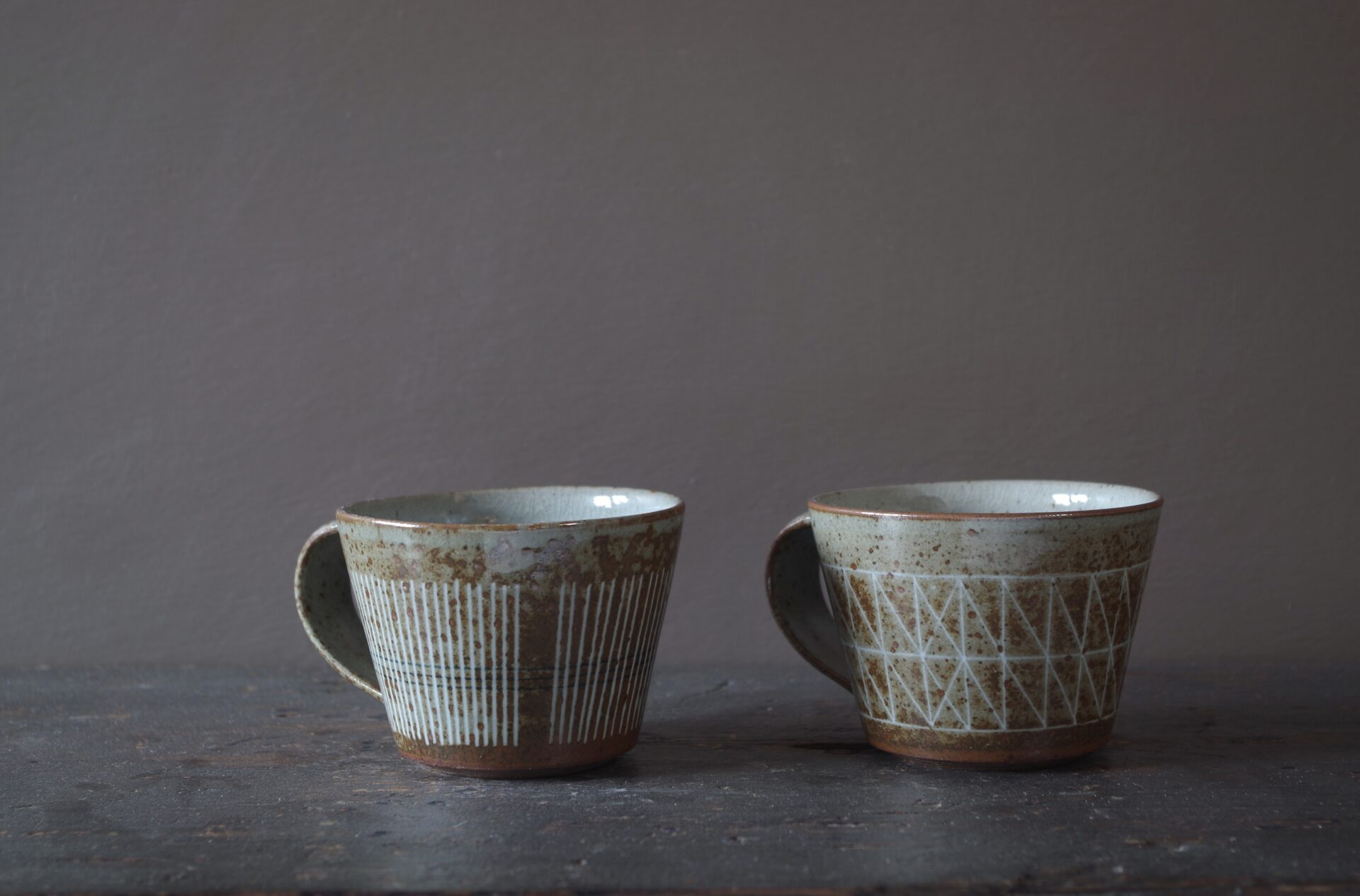 Reduction fired, wheel thrown, stoneware coffee cup with pulled handle and hand decorated with inlay by award winning studio potters James and Tilla Waters in Carmarthenshire, Wales, UK