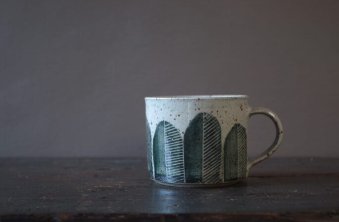 Reduction fired, wheel thrown, stoneware coffee can with pulled handle and hand decorated by award winning studio potters James and Tilla Waters in Carmarthenshire, Wales, UK