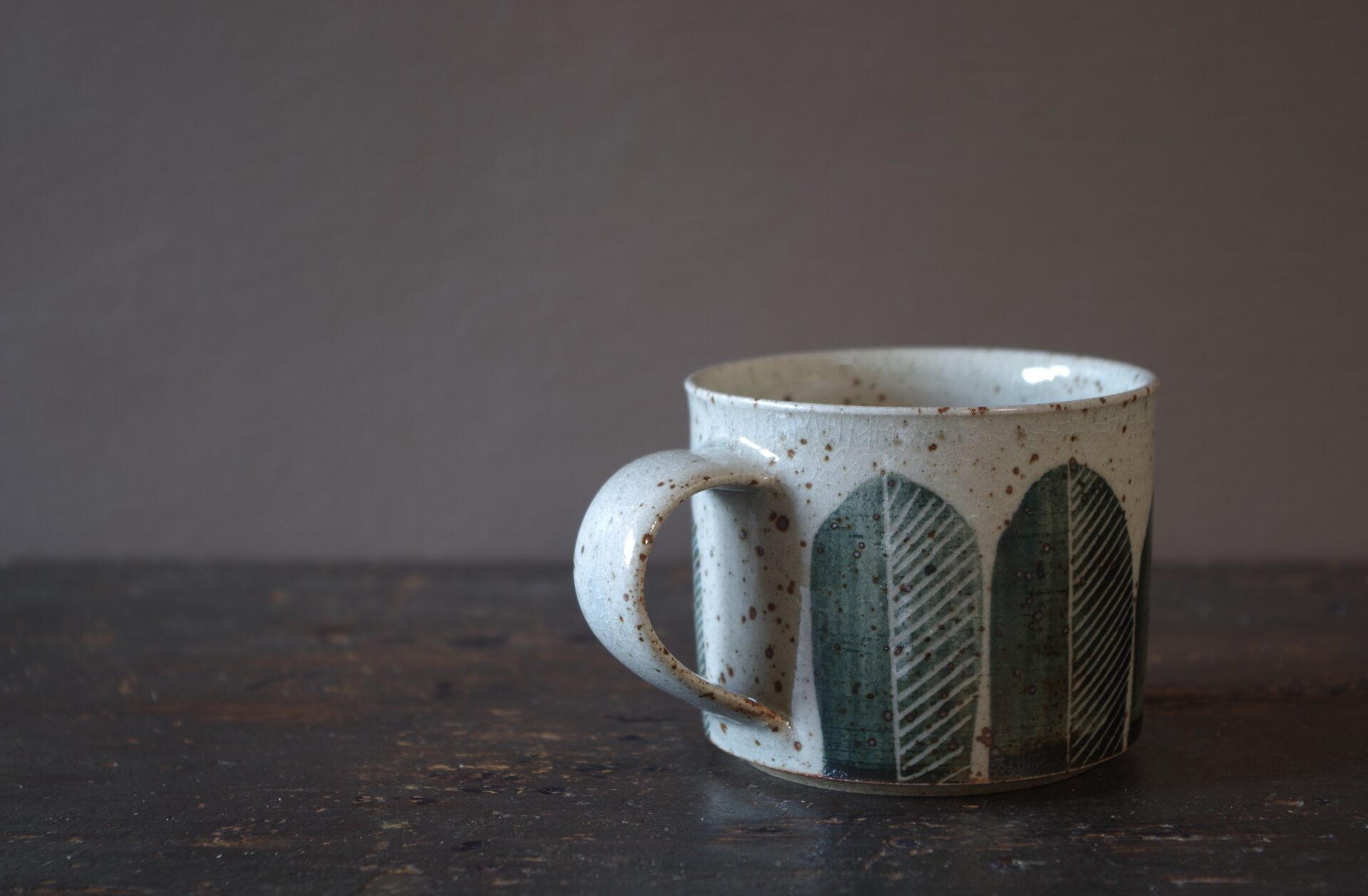 Reduction fired, wheel thrown, stoneware coffee can with pulled handle and hand decorated by award winning studio potters James and Tilla Waters in Carmarthenshire, Wales, UK