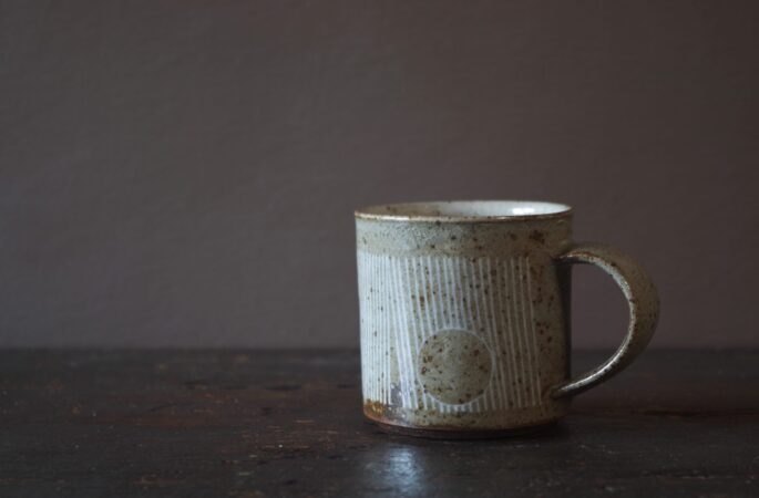 Reduction fired, wheel thrown, stoneware coffee can with pulled handle and hand decorated with inlay by award winning studio potters James and Tilla Waters in Carmarthenshire, Wales, UK
