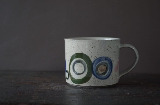 Reduction fired, wheel thrown, stoneware mug with pulled handle and hand decorated by award winning studio potters James and Tilla Waters in Carmarthenshire, Wales, UK