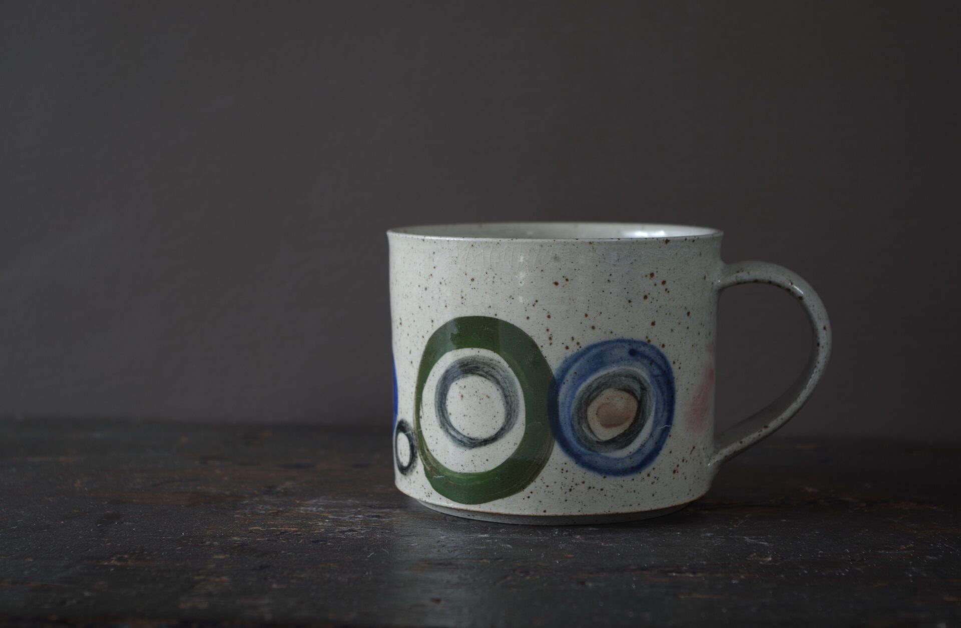 Reduction fired, wheel thrown, stoneware mug with pulled handle and hand decorated by award winning studio potters James and Tilla Waters in Carmarthenshire, Wales, UK