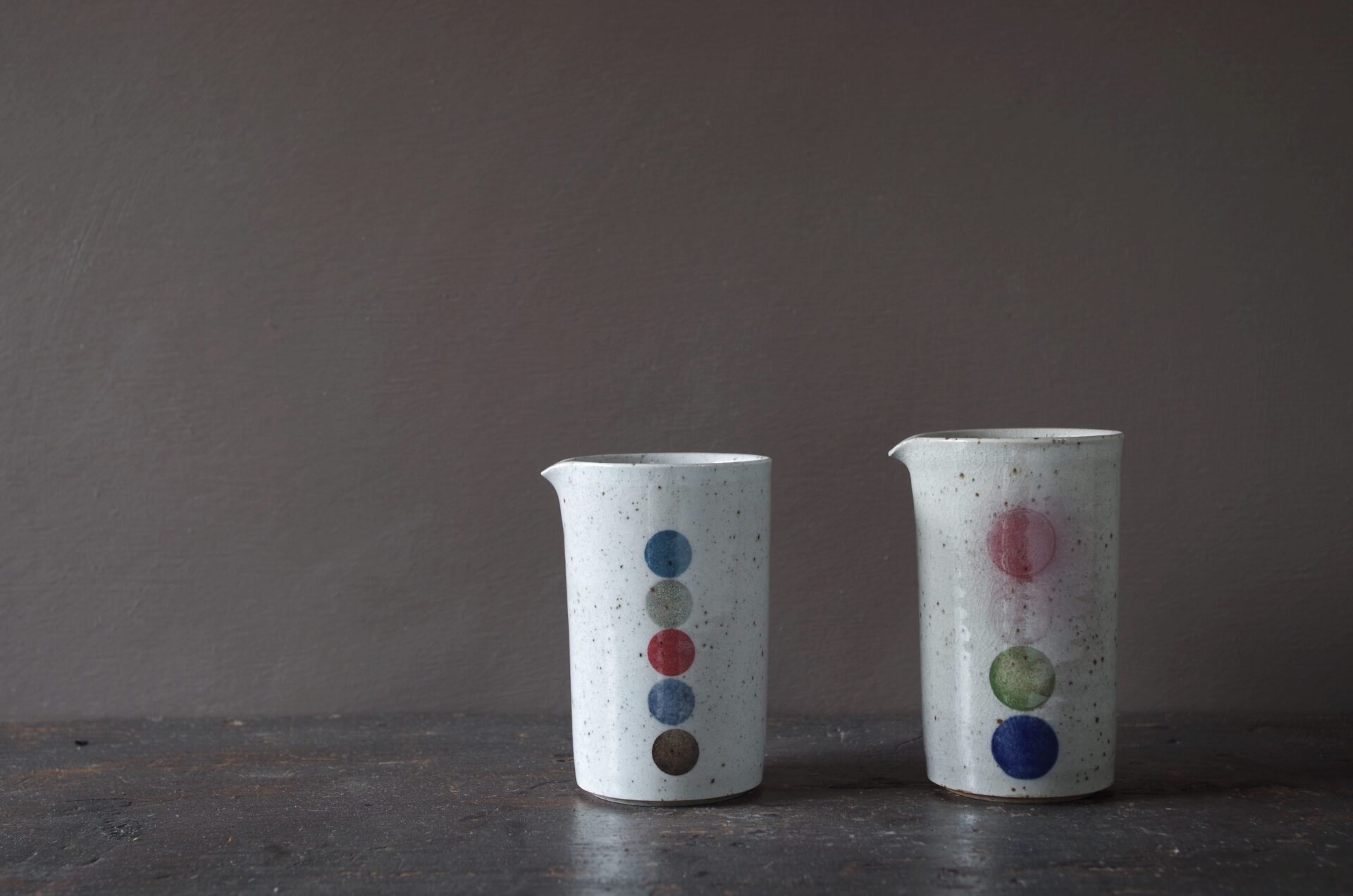 reduction fired, thrown stoneware small pourers with circle decoration by award winning potters James and Tilla Waters in Carmarthenshire, Wales, UK