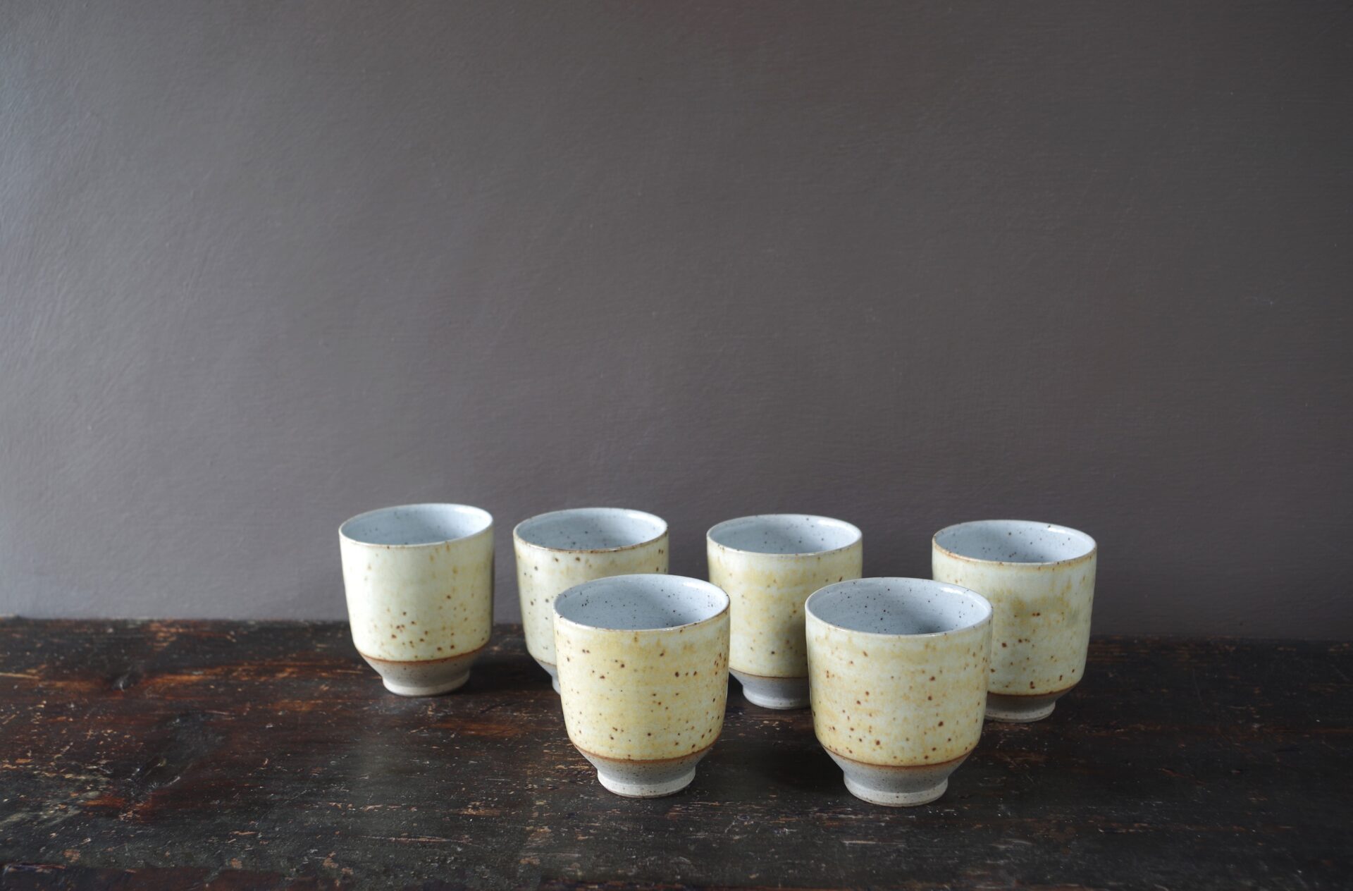 reduction fired thrown stoneware beaker with soft yellow glaze by award winning studio potters James and Tilla Waters in Carmarthenshire, Wales