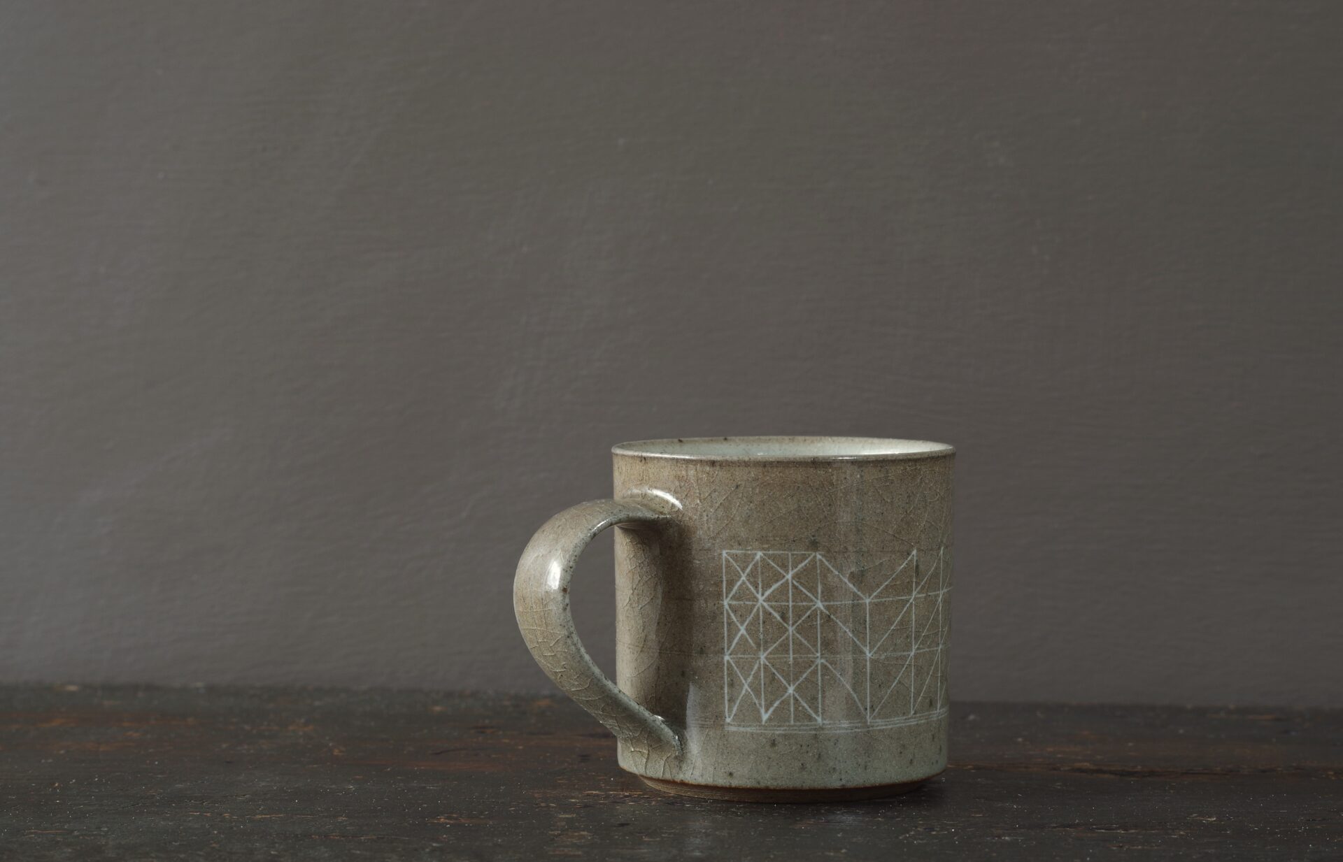 reduction fired stoneware mug (8cm x 8cm) with inlaid geometric decoration and pulled handle by award winning potters James and Tilla Waters in Carmartheshire, Wales, UK