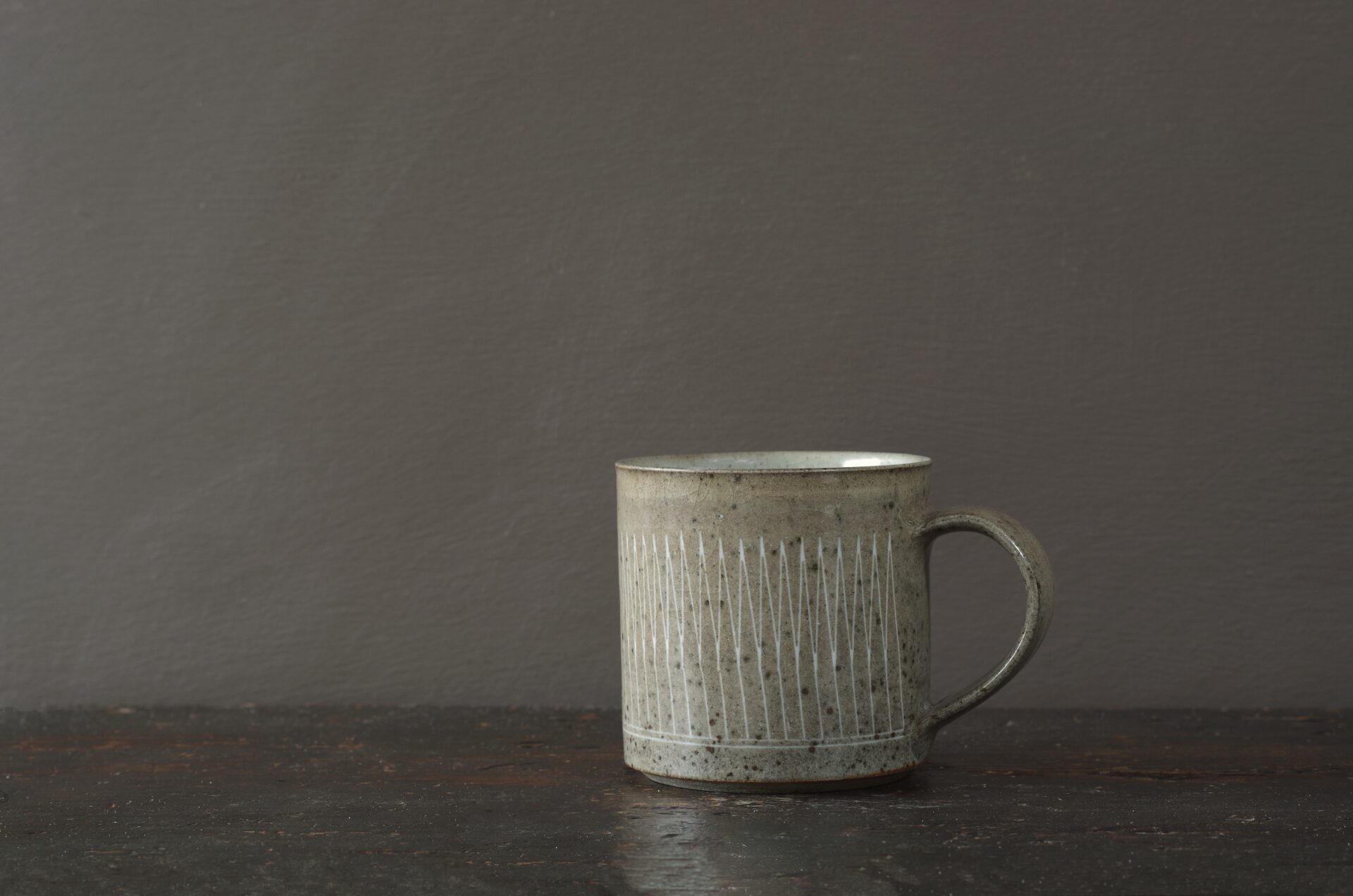 reduction fired stoneware mug (8cm x 8cm) with inlaid geometric decoration and pulled handle by award winning potters James and Tilla Waters in Carmartheshire, Wales, UK