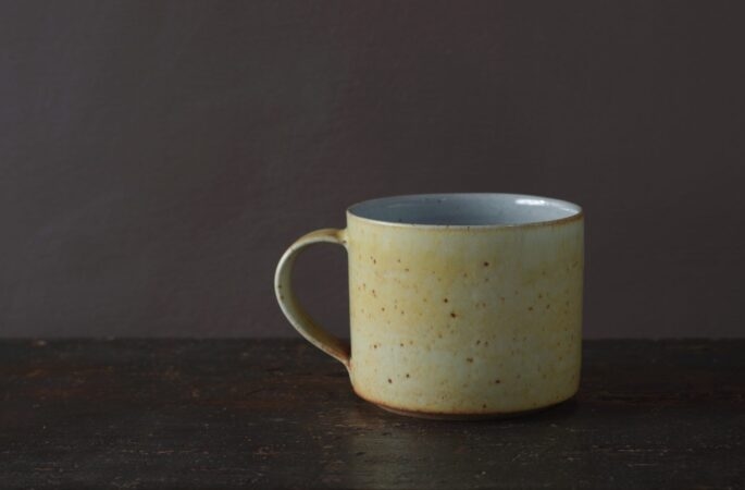 Wheel thrown reduction fired stoneware large breakfast mug with soft yellow glaze by award winning potters James and Tilla Waters in Carmarthenshire, Wales, UK