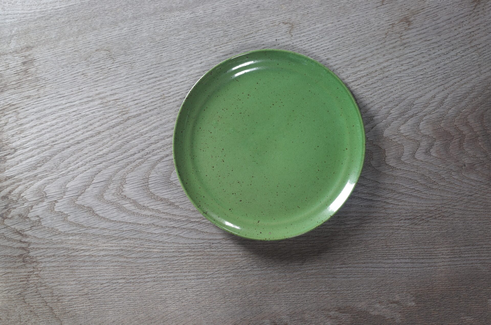 medium thrown stoneware dinner plate with chrome green glaze, fired in reduction by award winning studio potters James and Tilla Waters in Carmarthenshire, Wales UK