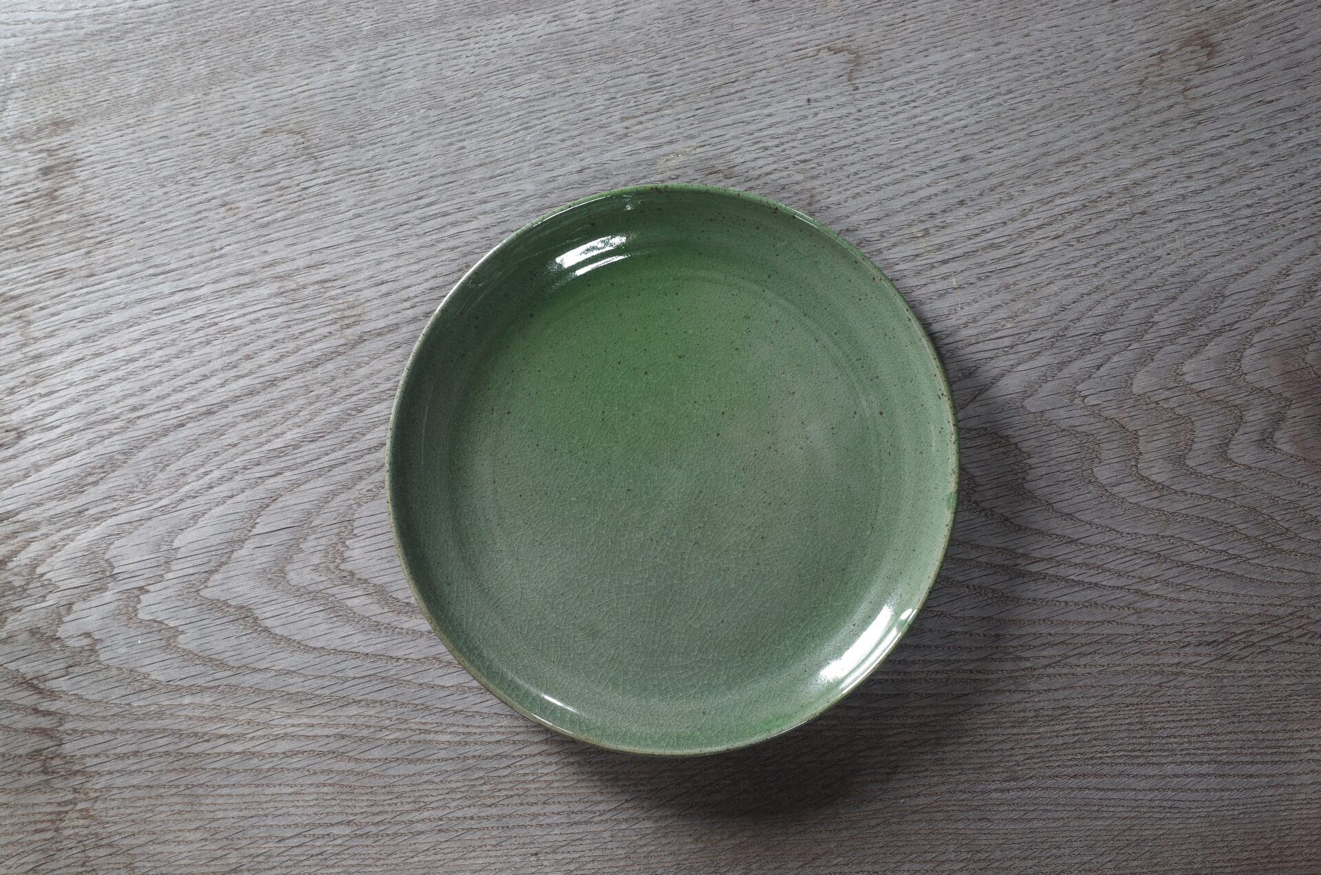 medium thrown stoneware dinner plate with chrome green glaze, fired in reduction by award winning studio potters James and Tilla Waters in Carmarthenshire, Wales UK