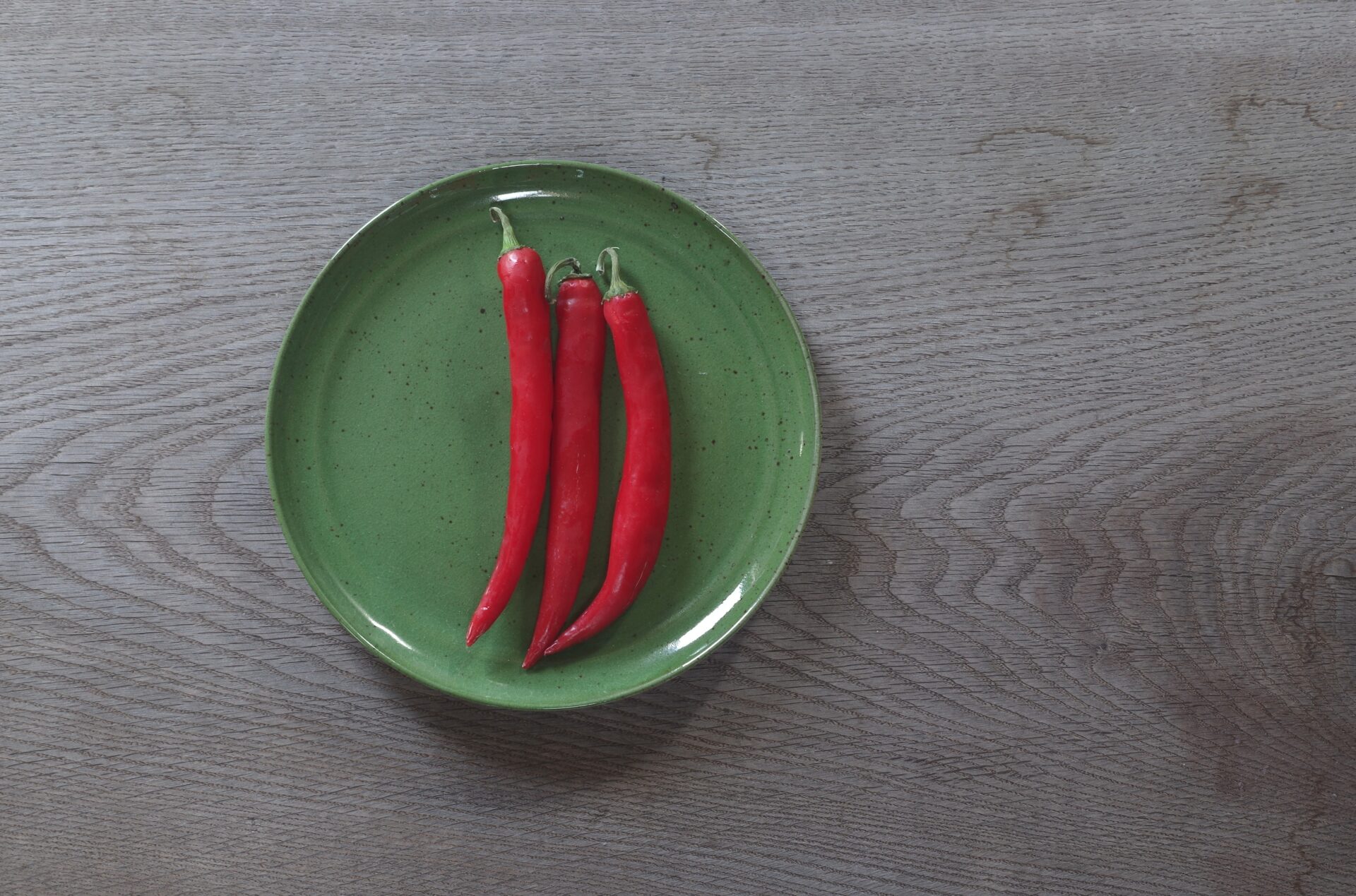 medium thrown stoneware dinner plate with chrome green glaze, fired in reduction by award winning studio potters James and Tilla Waters in Carmarthenshire, Wales UK
