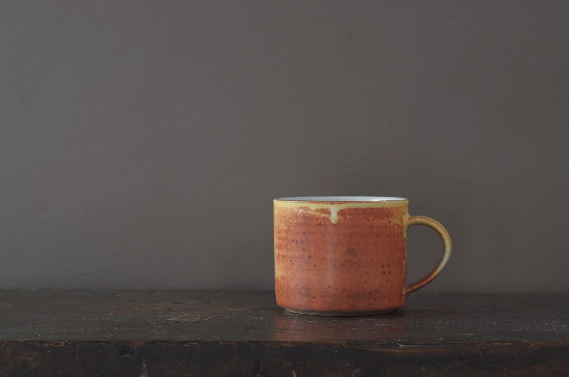 Wheel thrown reduction fired stoneware breakfast mug with rust yellow glaze by award winning potters James and Tilla Waters in Carmarthenshire, Wales, UK