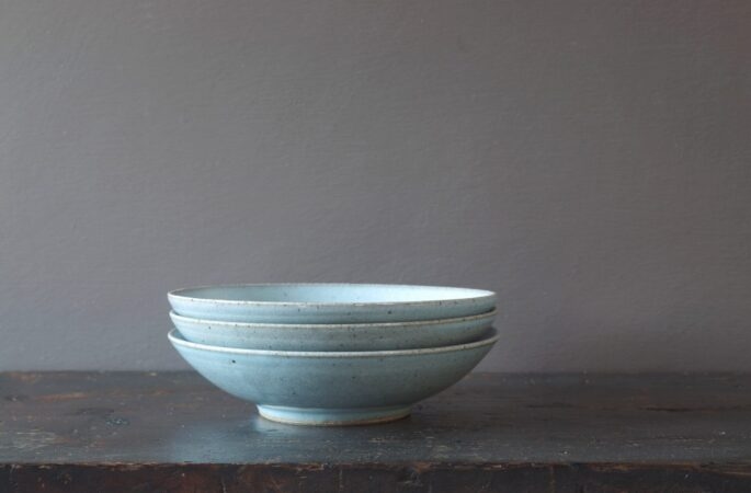 Thrown stoneware open bowl with pale blue chun glaze by award winning potters James and Tilla Waters in Carmarthenshire, Wales, UK