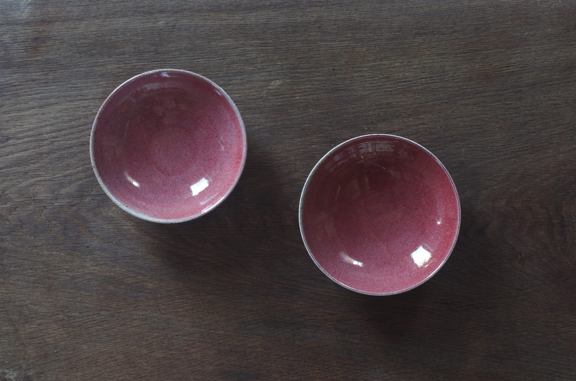 reduction fired, thrown stoneware open bowl with copper red glaze by award winning potters James and Tilla Waters in Carmarthenshire, Wales, UK
